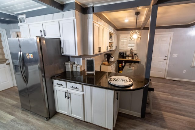 1602 27th St, Haleyville, AL 35565 - kitchen with stainless steel fridge with ice dispenser, wood finished floors, pendant lighting, white cabinets, and beam ceiling