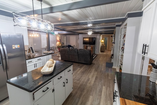 1602 27th St, Haleyville, AL 35565 - kitchen with stainless steel refrigerator with ice dispenser, wood finished floors, a kitchen island, white cabinetry, and a wooden ceiling with exposed beams
