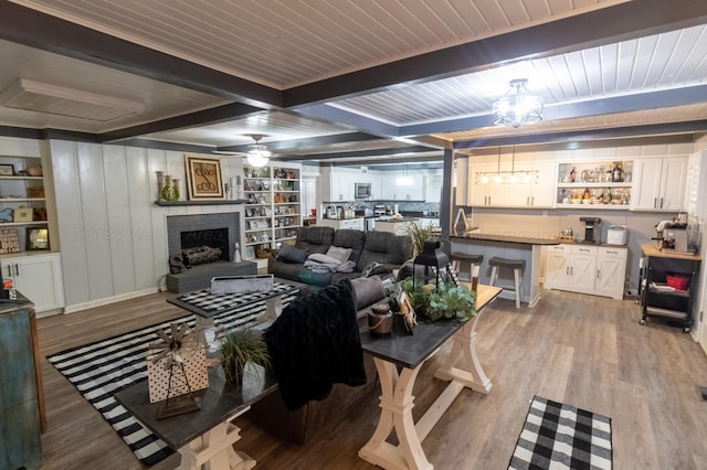 1602 27th St, Haleyville, AL 35565 - living room featuring a ceiling fan, light wood-style flooring, a fireplace with raised hearth, and a wooden ceiling with exposed beams