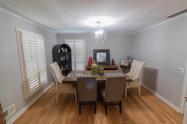 1602 27th St, Haleyville, AL 35565 - dining room featuring light wood-style flooring, a chandelier, and ornamental molding
