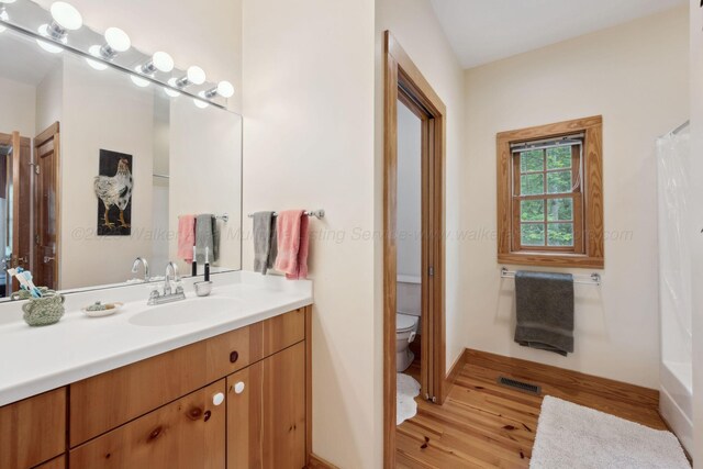 1617 S Stoney Rd, Double Springs, AL 35553 - full bathroom featuring wood finished floors, toilet, vanity, and baseboards