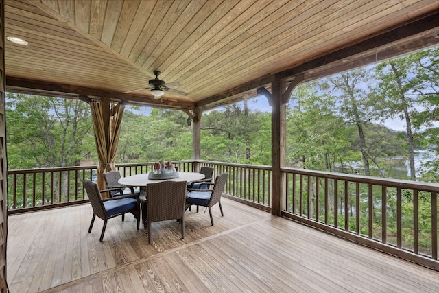 1617 S Stoney Rd, Double Springs, AL 35553 - wooden terrace with outdoor dining area, a ceiling fan, and view of wooded area
