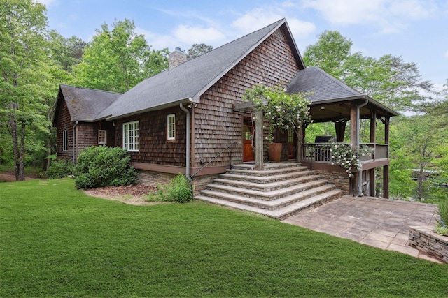 1617 S Stoney Rd, Double Springs, AL 35553 - view of front facade with a front yard, roof with shingles, a chimney, and a patio