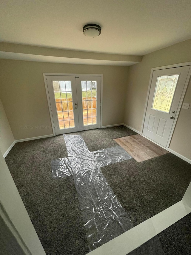 carpeted entryway featuring french doors and baseboards