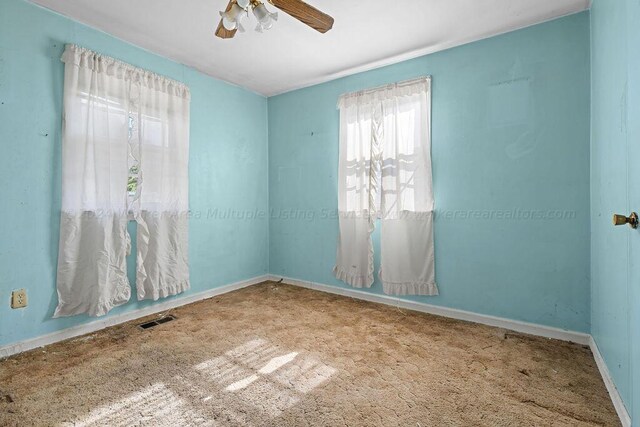 carpeted empty room with ceiling fan