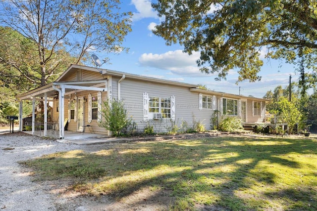 view of front of house featuring cooling unit and a front lawn