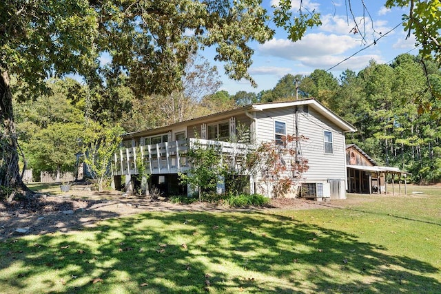 back of house featuring a yard and central AC