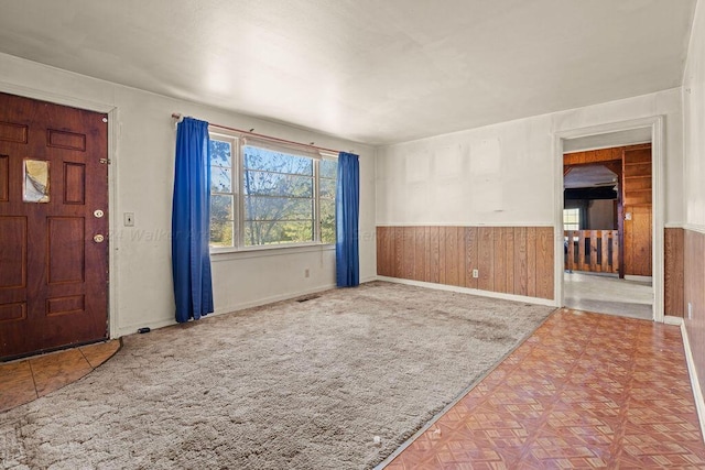 foyer with wooden walls