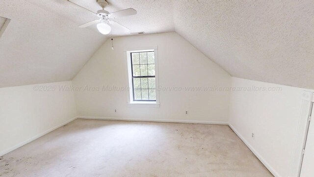 1704 Sharon Ln, Jasper, AL 35504 - bonus room featuring carpet flooring, a textured ceiling, a ceiling fan, baseboards, and lofted ceiling