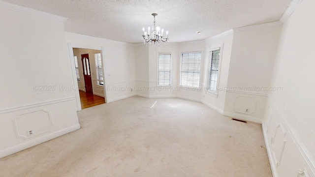 1704 Sharon Ln, Jasper, AL 35504 - carpeted spare room featuring crown molding, visible vents, a textured ceiling, and a notable chandelier