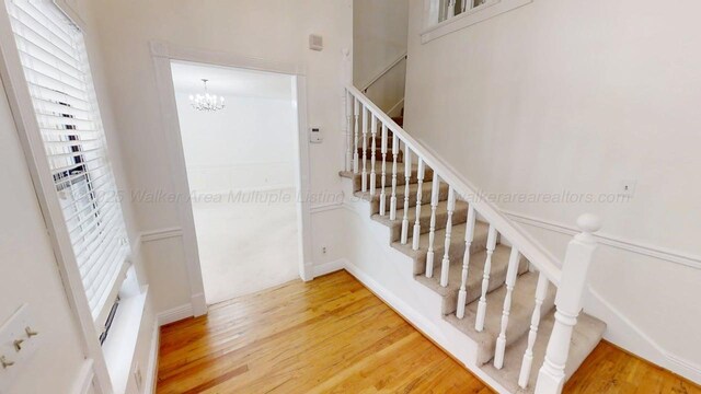 1704 Sharon Ln, Jasper, AL 35504 - stairway with an inviting chandelier and wood finished floors