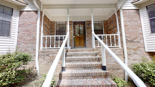 1704 Sharon Ln, Jasper, AL 35504 - property entrance with brick siding, roof with shingles, and a porch