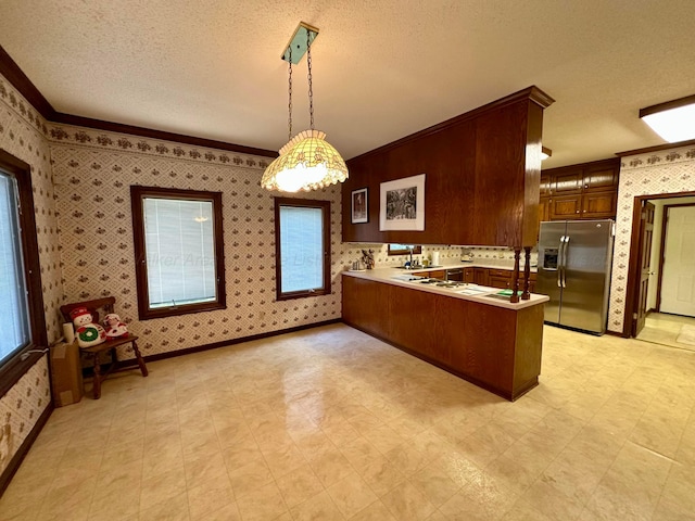 542 Llama Ln, Quinton, AL 35130 - kitchen featuring stainless steel fridge with ice dispenser, a textured ceiling, a peninsula, wallpapered walls, and crown molding