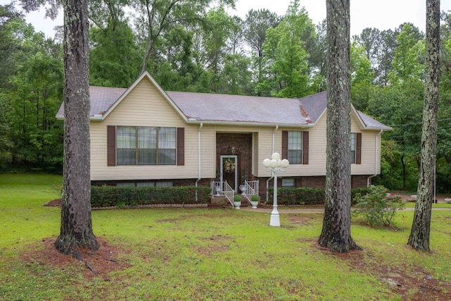 1925 Sharon Blvd, Dora, AL 35062 - bi-level home featuring a front yard, brick siding, and view of scattered trees