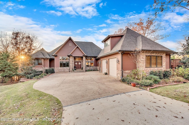 60 Sunset Dr, Arley, AL 35541 - craftsman-style house featuring stone siding, concrete driveway, roof with shingles, and a front lawn