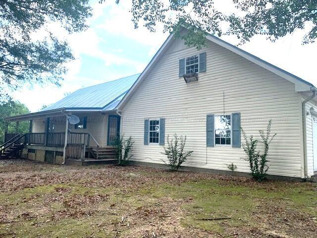 rear view of house featuring a porch