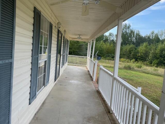 view of patio with ceiling fan and a porch