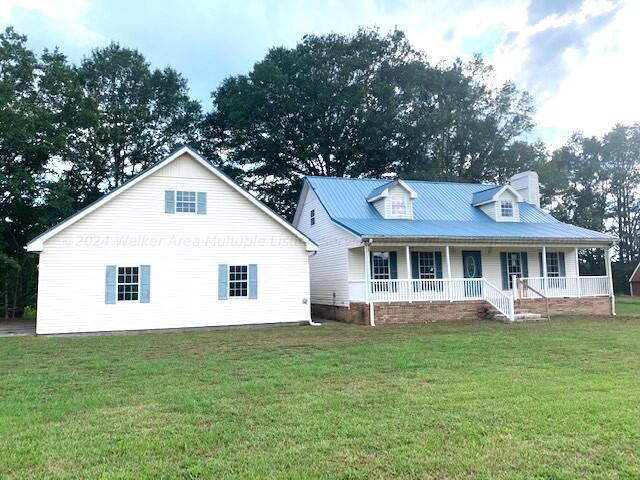 view of front of house with covered porch and a front yard