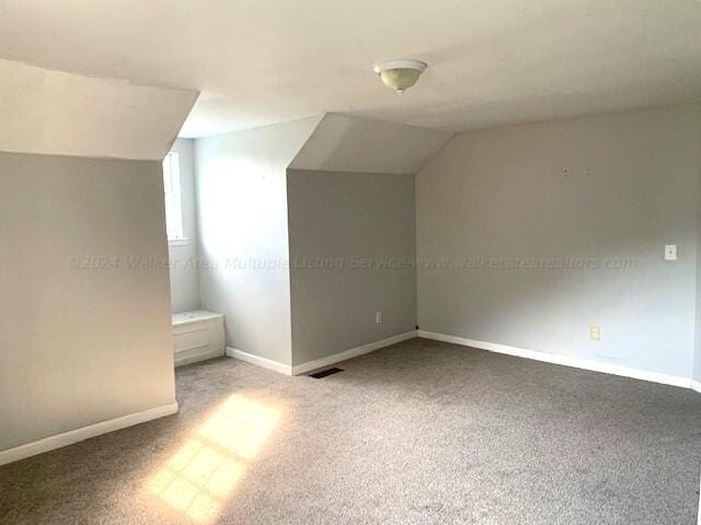 bonus room featuring baseboards, carpet flooring, and lofted ceiling
