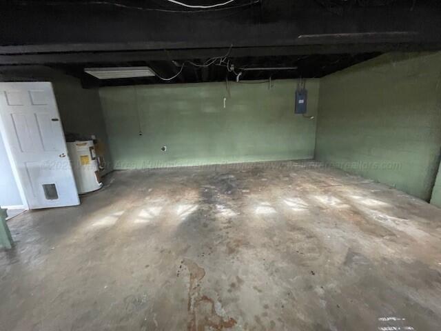 garage with water heater and electric panel