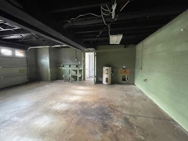 garage with concrete block wall and electric water heater