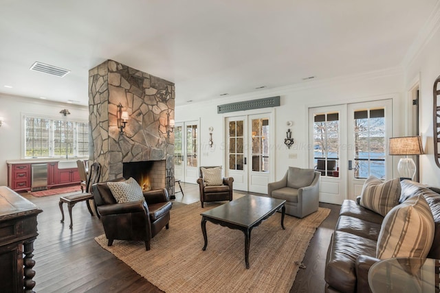 living room with visible vents, ornamental molding, and french doors