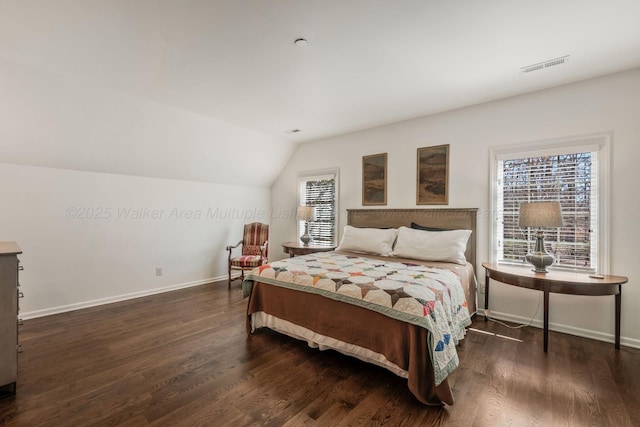 bedroom with baseboards, wood finished floors, and visible vents