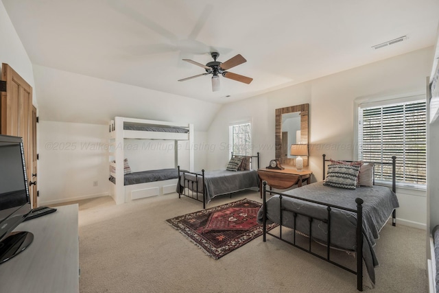 carpeted bedroom with ceiling fan, baseboards, vaulted ceiling, and visible vents