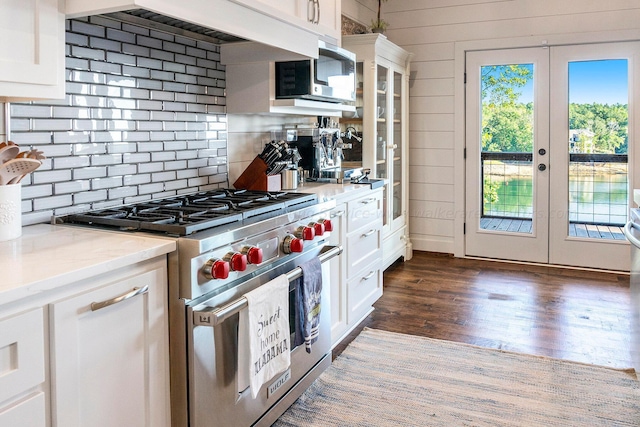 kitchen featuring white cabinets, appliances with stainless steel finishes, light stone countertops, and french doors