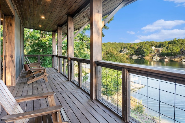 wooden terrace featuring a water view and covered porch