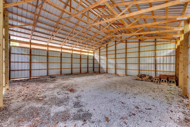 misc room featuring vaulted ceiling and metal wall