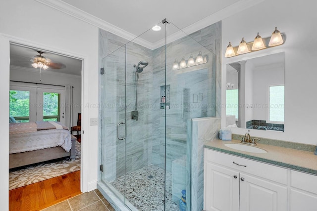 bathroom featuring crown molding, tile patterned flooring, vanity, ensuite bath, and a stall shower