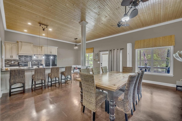 dining area with concrete flooring, baseboards, ornamental molding, and wood ceiling