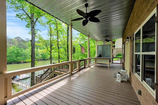 wooden deck featuring a ceiling fan and a water view