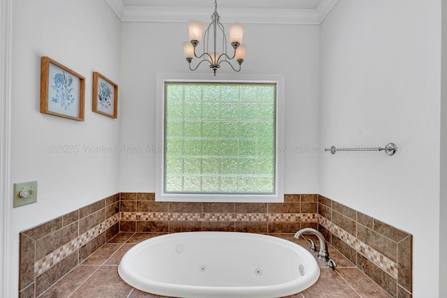 bathroom featuring ornamental molding, a tub with jets, and a notable chandelier