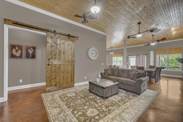 living room featuring baseboards, a ceiling fan, concrete flooring, and ornamental molding