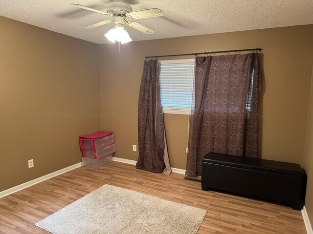 4407 Pineywoods Sipsey Rd, Jasper, AL 35504 - empty room featuring wood finished floors, a ceiling fan, baseboards, and a textured ceiling