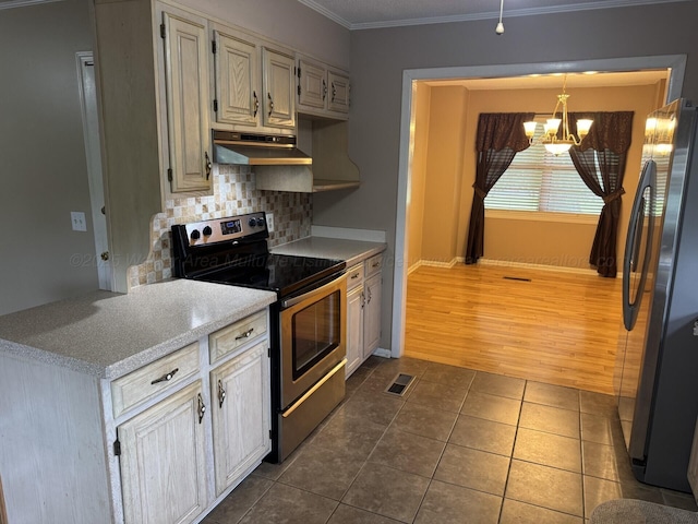 4407 Pineywoods Sipsey Rd, Jasper, AL 35504 - kitchen with appliances with stainless steel finishes, under cabinet range hood, a chandelier, decorative backsplash, and dark tile patterned floors