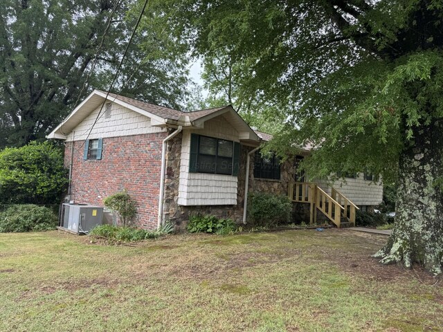 4407 Pineywoods Sipsey Rd, Jasper, AL 35504 - view of side of home with stone siding, cooling unit, and a lawn
