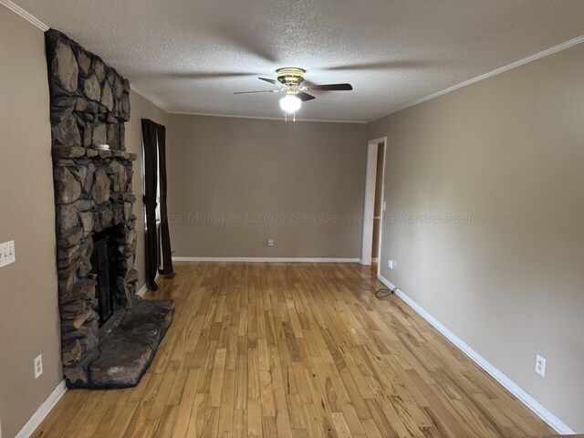 4407 Pineywoods Sipsey Rd, Jasper, AL 35504 - unfurnished living room featuring a ceiling fan, a textured ceiling, wood finished floors, crown molding, and baseboards