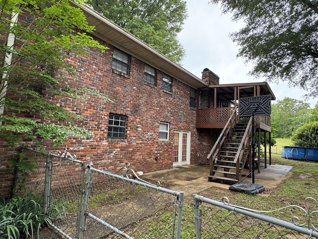4407 Pineywoods Sipsey Rd, Jasper, AL 35504 - back of house with a gate, a fenced backyard, and brick siding