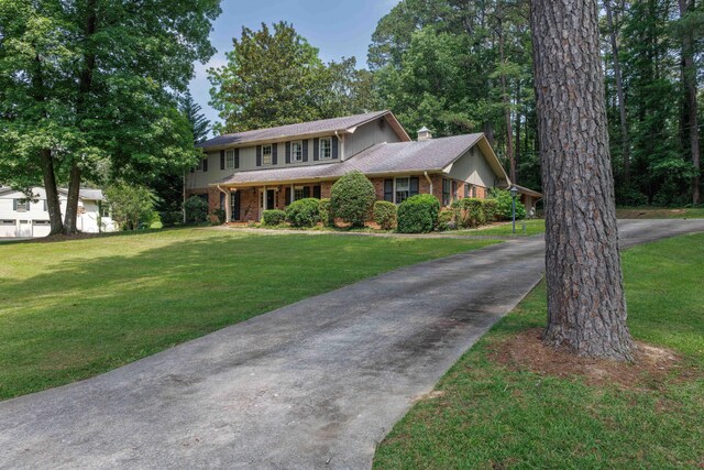 1004 Quarry Rd, Jasper, AL 35501 - view of front of property featuring a chimney, brick siding, a front yard, and driveway