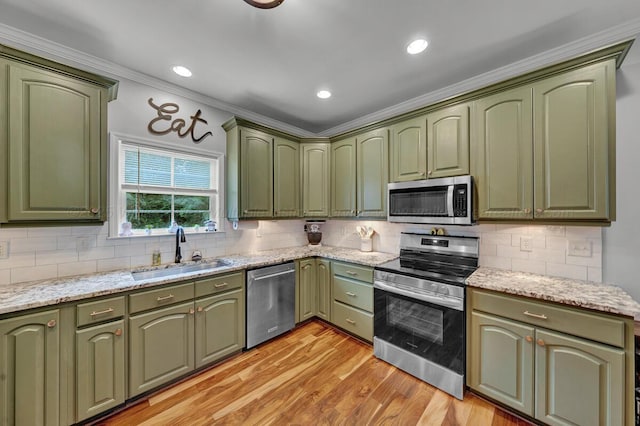 539 Hayfield Dr, Dora, AL 35062 - kitchen with green cabinetry, appliances with stainless steel finishes, ornamental molding, light wood finished floors, and backsplash