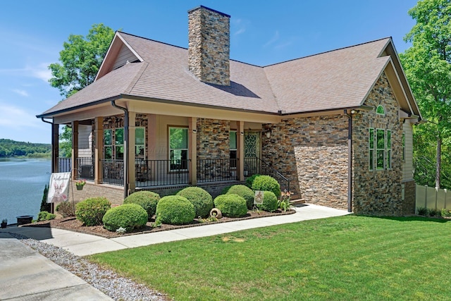 154 County Rd 389, Cullman, AL 35057 - view of front of property with stone siding, a front lawn, a chimney, roof with shingles, and covered porch