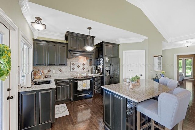 154 County Rd 389, Cullman, AL 35057 - kitchen featuring black fridge, range with electric stovetop, a sink, a kitchen bar, and decorative backsplash