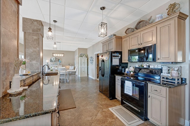 154 County Rd 389, Cullman, AL 35057 - kitchen with black appliances, a paneled ceiling, dark stone countertops, hanging light fixtures, and light tile patterned flooring