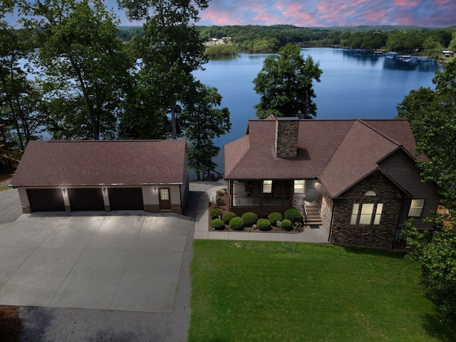 154 County Rd 389, Cullman, AL 35057 - view of front of home with a porch, stone siding, driveway, a yard, and a water view