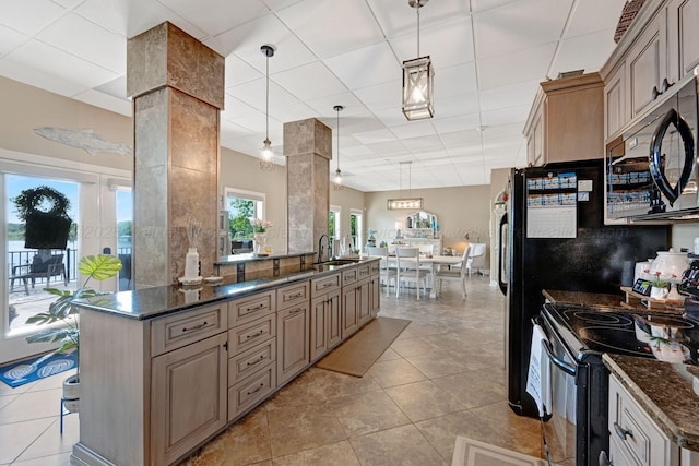 154 County Rd 389, Cullman, AL 35057 - kitchen with black appliances, a sink, a paneled ceiling, hanging light fixtures, and light tile patterned flooring