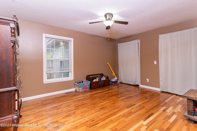 12 Dover Rd, Haleyville, AL 35565 - unfurnished bedroom with a textured ceiling, visible vents, light wood-style flooring, a ceiling fan, and baseboards