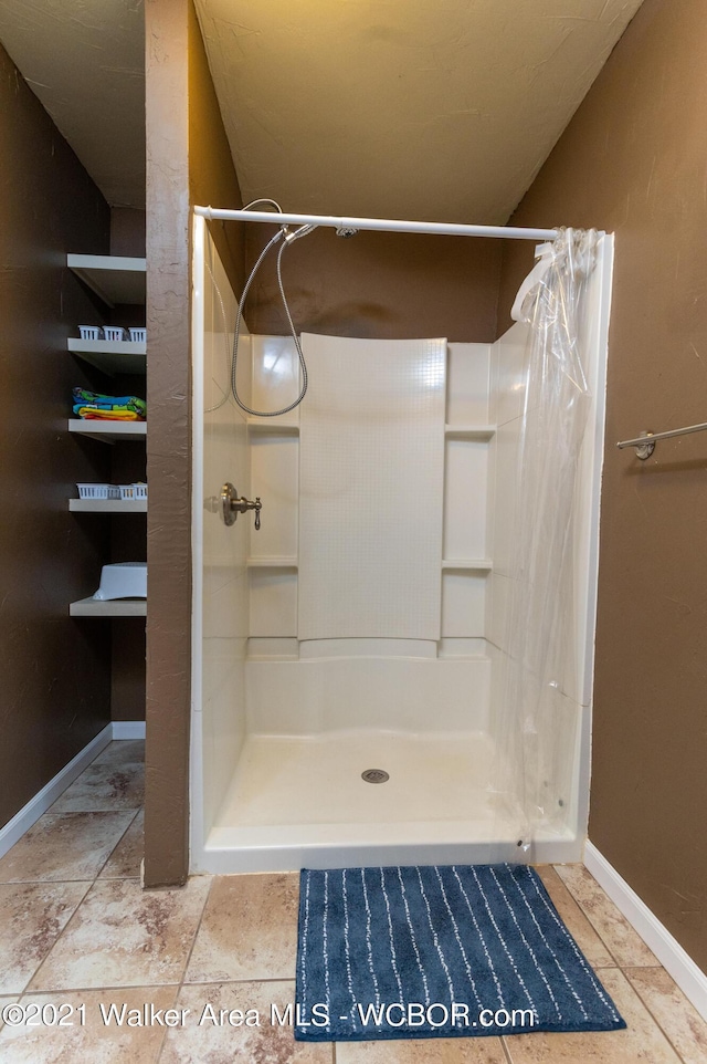12 Dover Rd, Haleyville, AL 35565 - bathroom with a stall shower and baseboards
